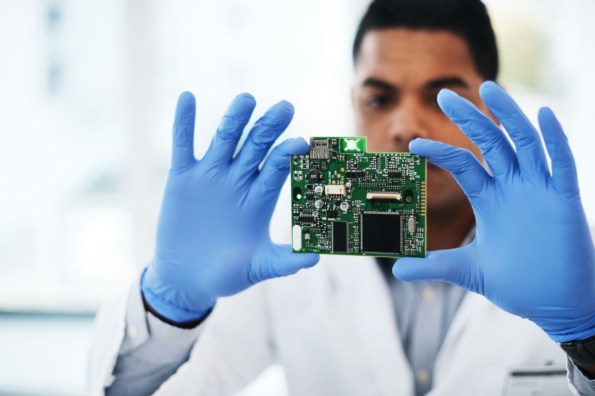Engineer examining a PCB board on the assembly line