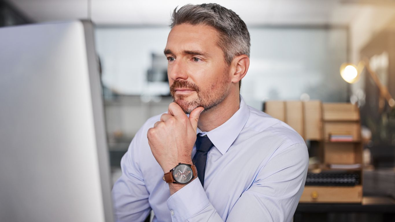 Man contemplating a process while at his desk