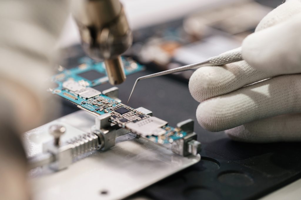 A circuit board is being put together