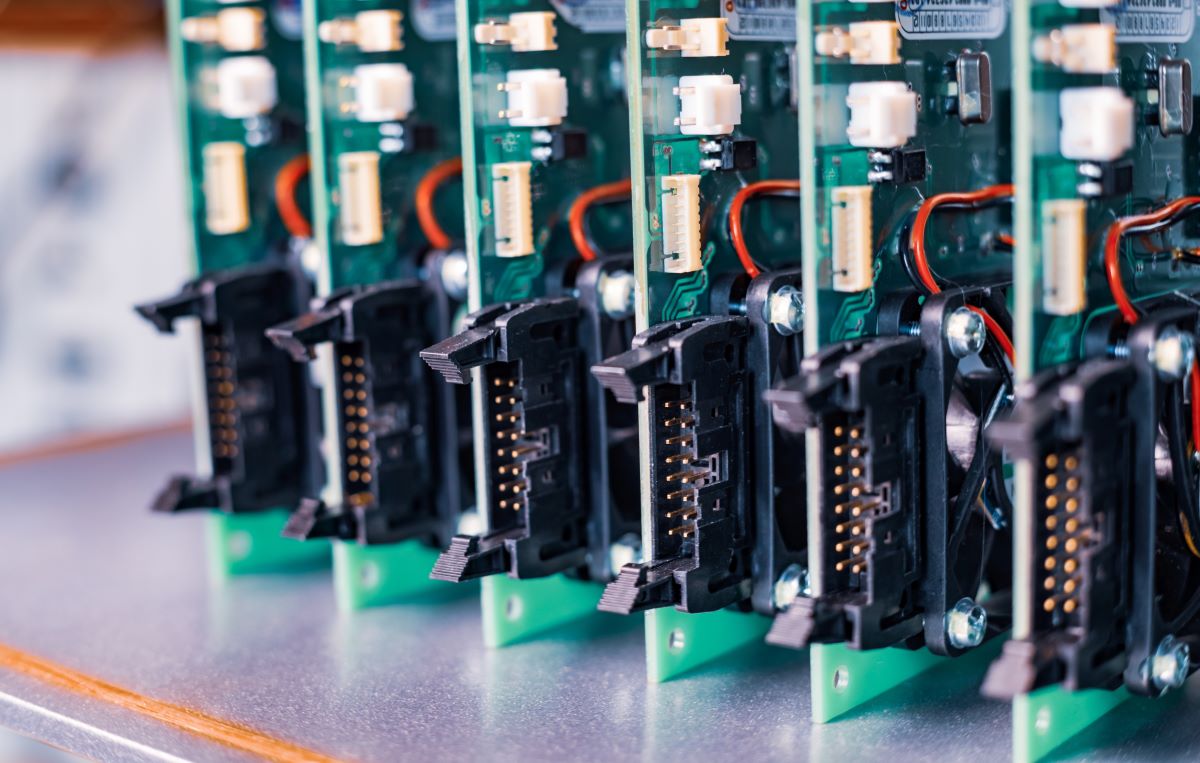 Close-up of electric green embedded microcircuits in production