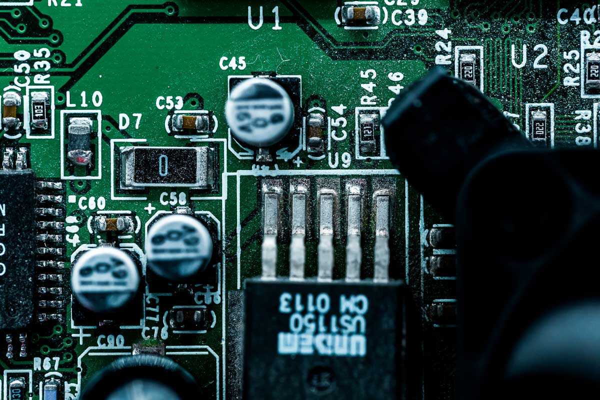 close-up of a printed circuit board (PCB) showing electronic components, resistors, and capacitors