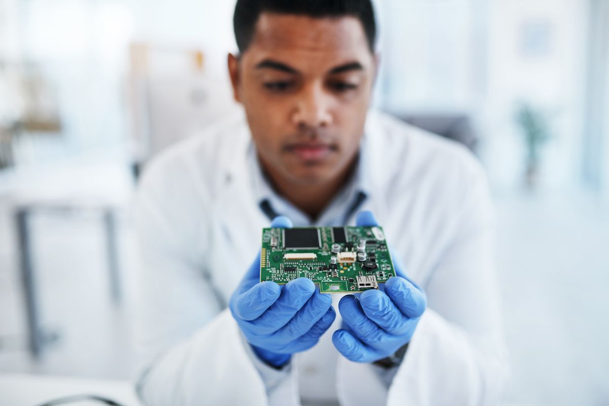 Engineer examining a PCB circuit board